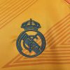 maillotrealmadridexterieurorangelogo.jpg Real Madrid Uitshirt 2024-2025 stofdetail